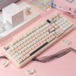 Angelic black and pink PBT Cupid Keycaps set, showcasing unique dye-sublimated cherub, heart, and arrow designs from various playful angles.