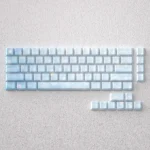 Serene Dawn PBT keycaps set for mechanical keyboards, showcasing tranquil sunrise gradients and elegant front-printed legends. Crafted from durable PBT.