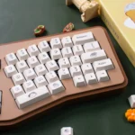 A charming gallery of PBT dye-sublimated dessert keycaps set, featuring delightful pastel cakes, donuts, and candies from various angles.