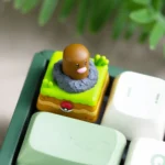 A collection of detailed images showcasing the whimsical rotating Diglett & Psyduck Keycaps from multiple angles, highlighting its unique handcrafted design.