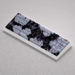 Elegant PBT floral keycaps set in Cherry profile, showcasing subtle botanical designs from multiple angles, perfect for a serene desktop upgrade on compact.