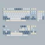 Eternity Moon on Sea magnetic keycaps set, shown from various angles, revealing serene blue, luminous white, and ethereal ocean reflections.