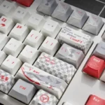 Collection of F1 Keycaps Set featuring the exclusive Alfa Romeo C42 Zhou Guanyu theme, presented from multiple dynamic angles.