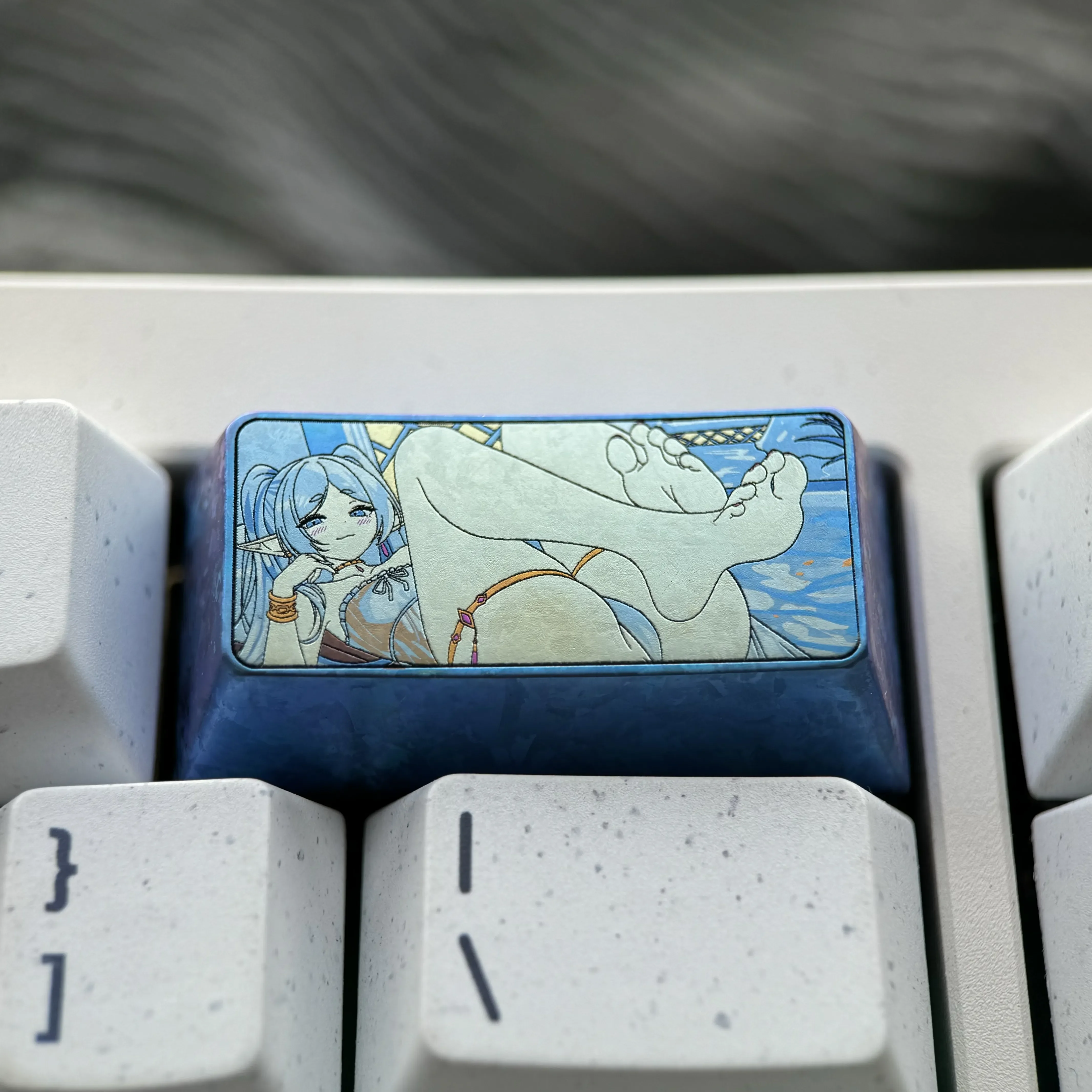 Handcrafted Frieren Keycap: a vibrant titanium 2U backspace keycap showcasing intricate Frieren anime art and exquisite elven details.