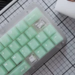 Ethereal Frosted Emerald PC Keycaps Set from various angles, highlighting the refreshing frosted emerald green translucent keycaps and modern design.