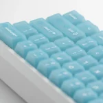 Refreshing frosted light blue PC keycaps set, elegantly displayed from multiple angles to highlight their unique translucent design.