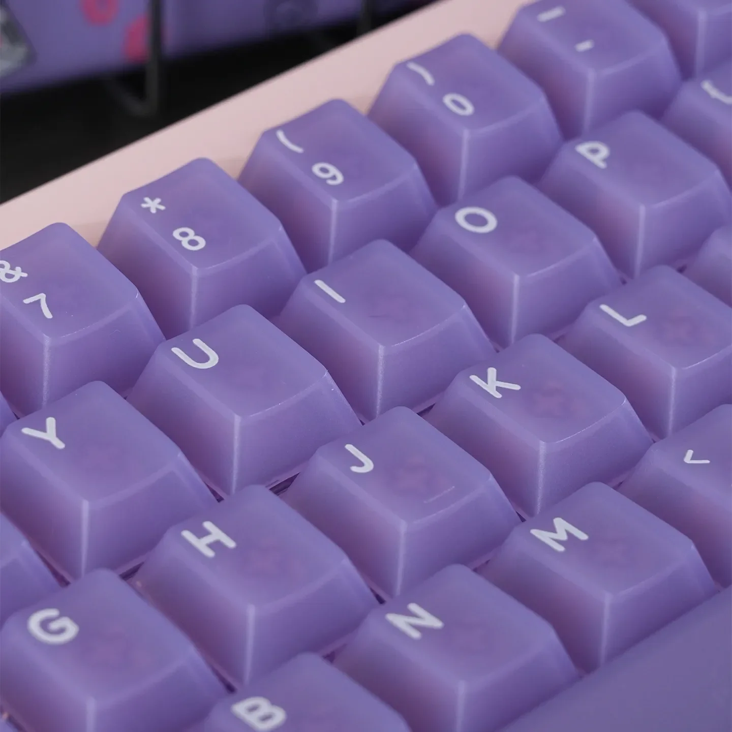 An ethereal collection of light purple frosted PC keycaps set, beautifully showcasing their soft, candy-like pastel translucence from diverse angles.