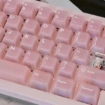 Ethereal frosted pink translucent PC keycaps set displayed from multiple angles, showcasing its soft pastel glow and modern, dreamy aesthetic.