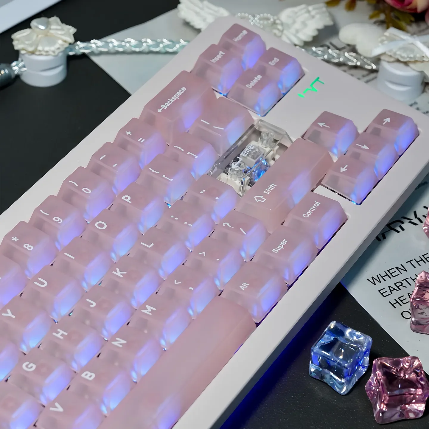 Close-up view of ethereal frosted pink translucent keycaps set, highlighting their soft glow and premium finish from various angles.
