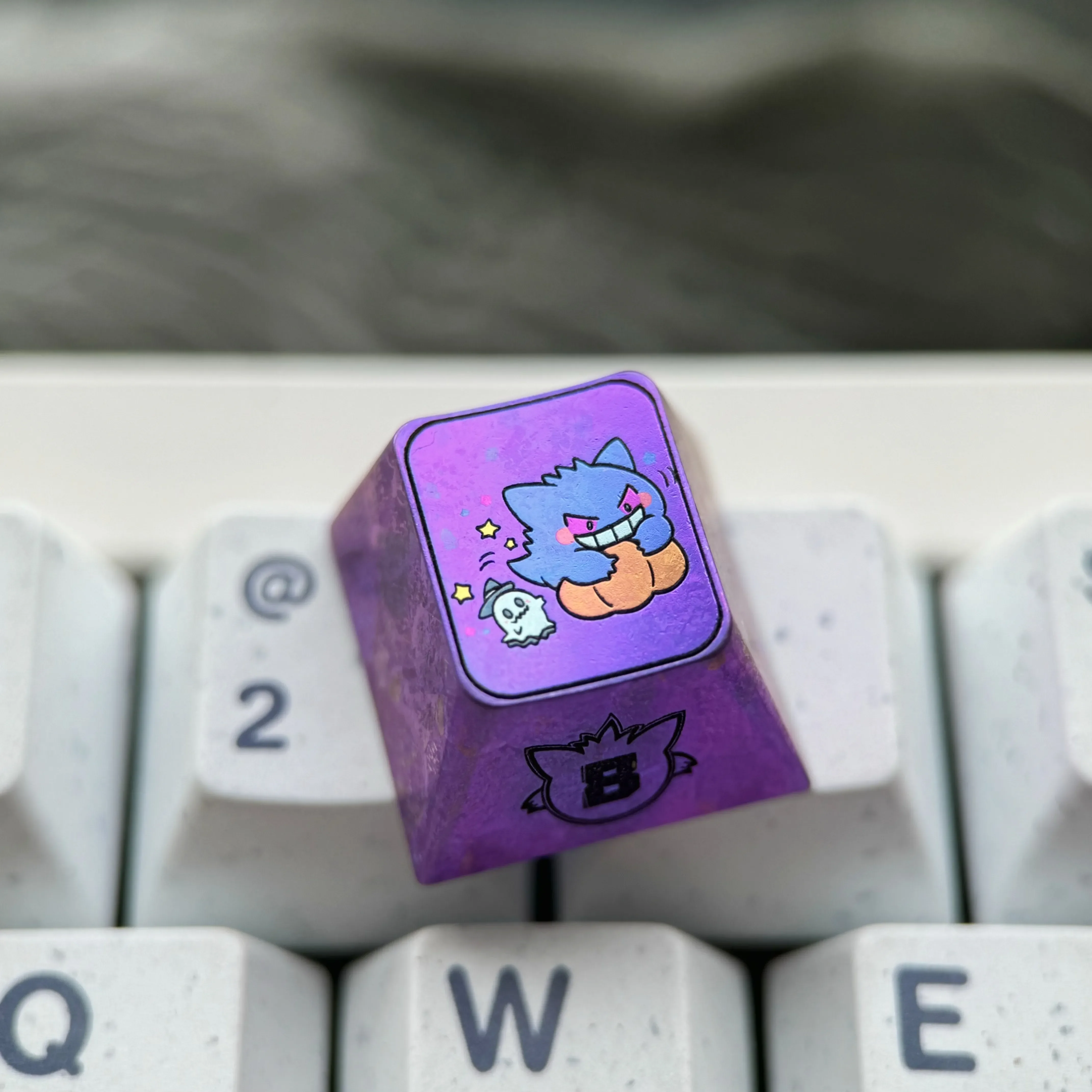 Premium titanium alloy Gengar artisan keycap featuring a stylized metallic purple Pokemon design for custom mechanical keyboards.