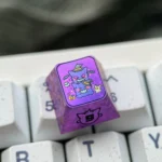 Premium Gengar artisan keycap, expertly crafted from titanium alloy, showcasing a vibrant metallic purple finish and stylized Gengar character.