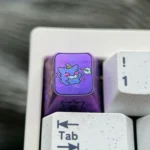 Premium titanium alloy Gengar artisan keycap, showcasing its stylized metallic purple finish for mechanical keyboards with artistic design.