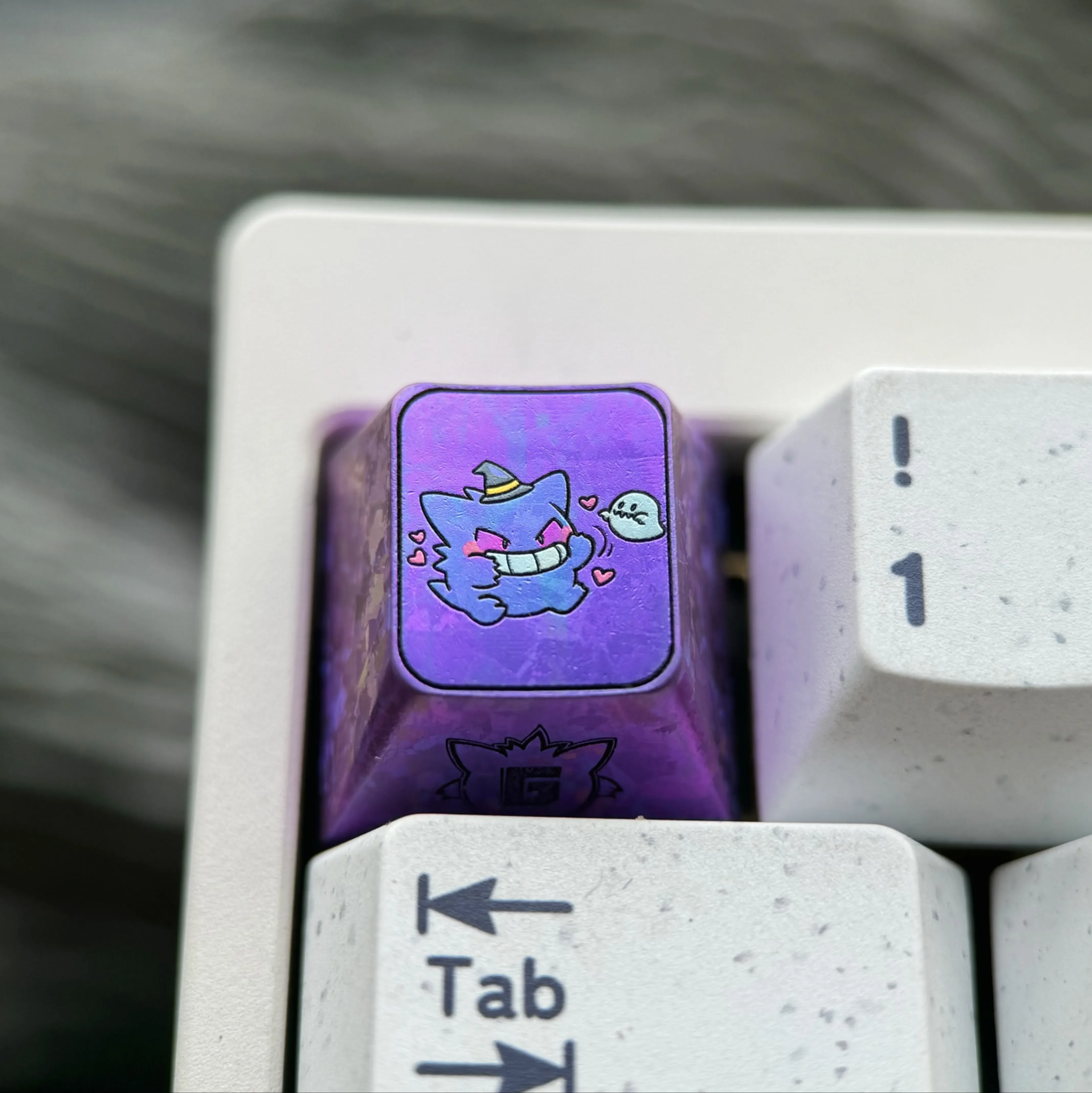 Premium titanium alloy Gengar artisan keycap, showcasing its stylized metallic purple finish for mechanical keyboards with artistic design.