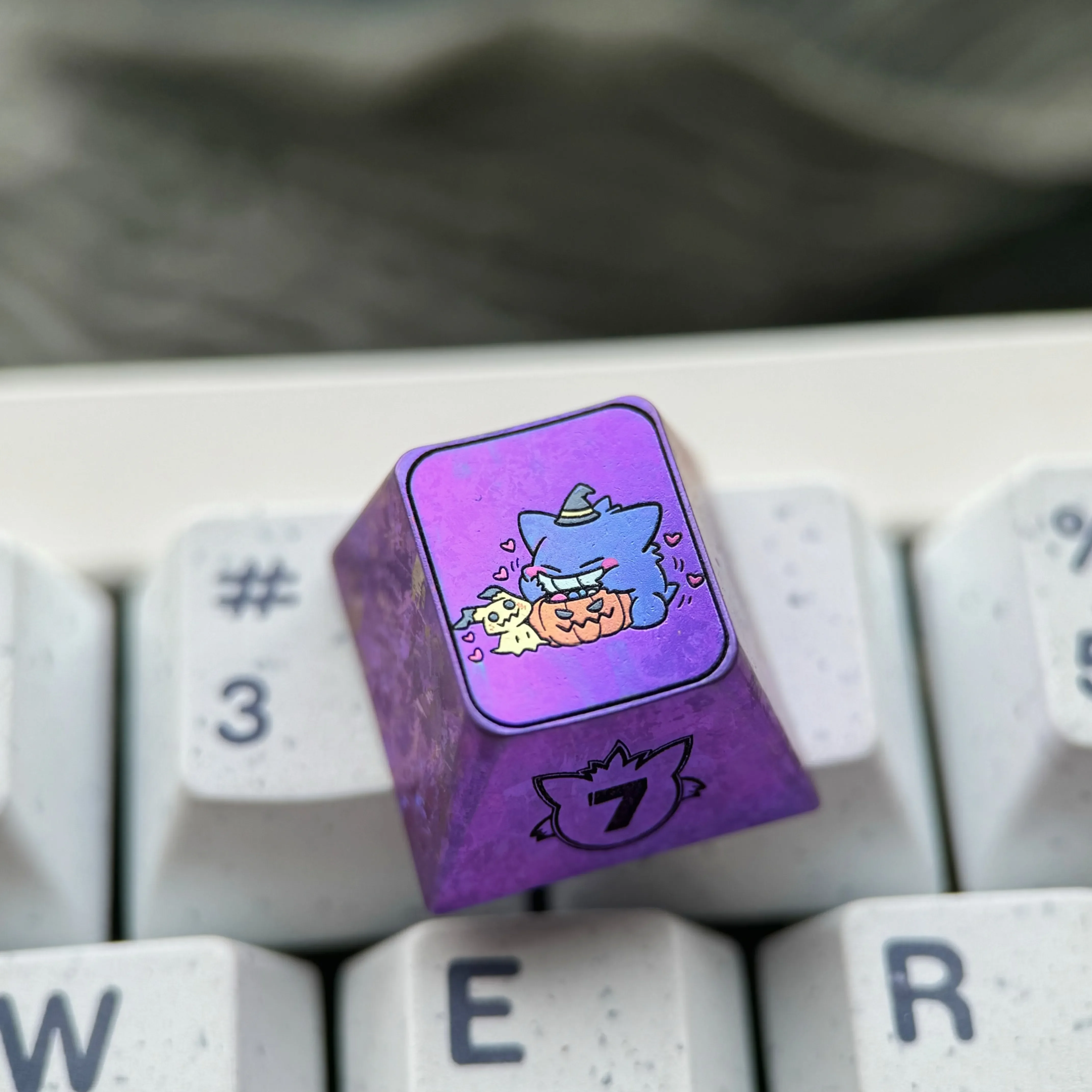 Premium titanium alloy Gengar artisan keycap, showcasing a stylized Gengar with a striking metallic purple finish and artistic design.