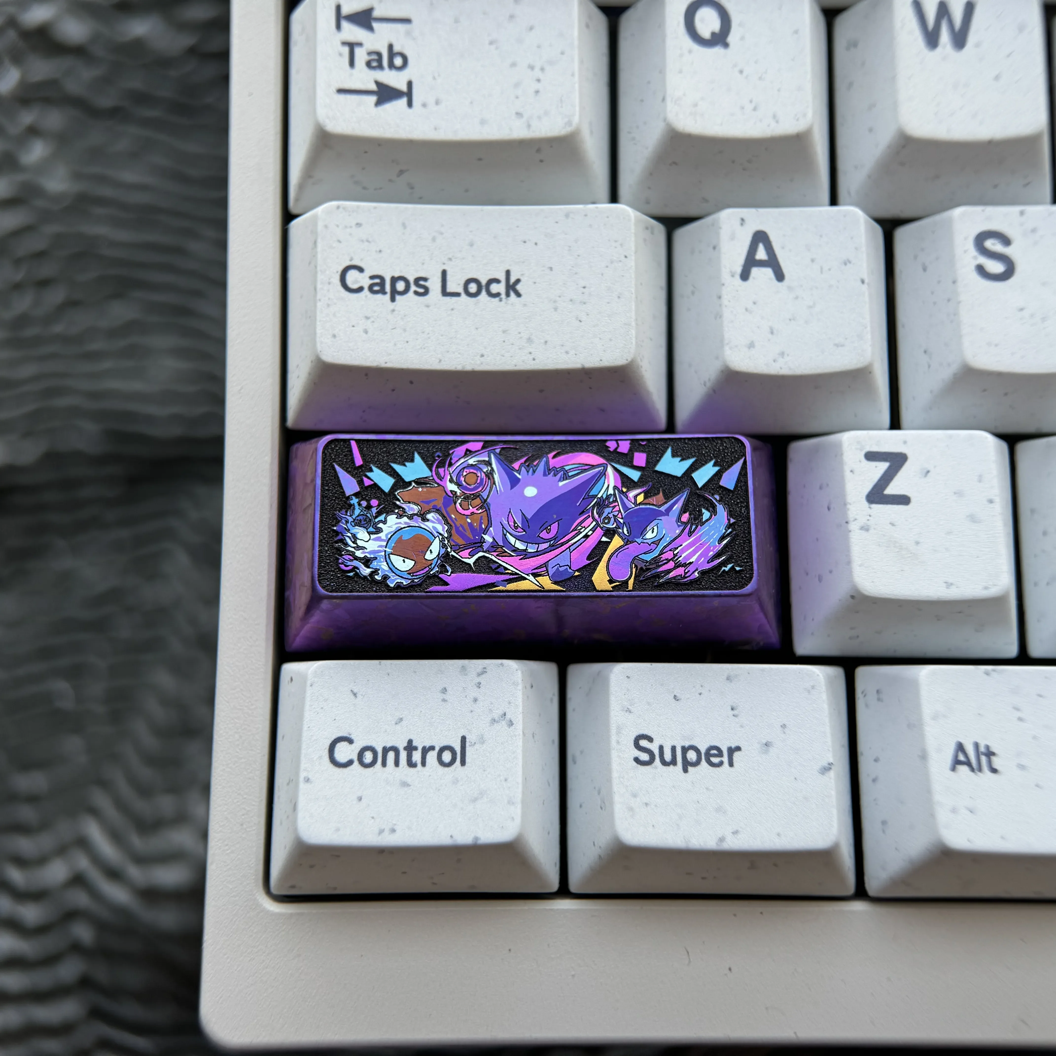 Playful Gengar keycap crafted from premium titanium, featuring a vibrant, intricately sculpted anime-inspired Gengar for a custom mechanical keyboard.