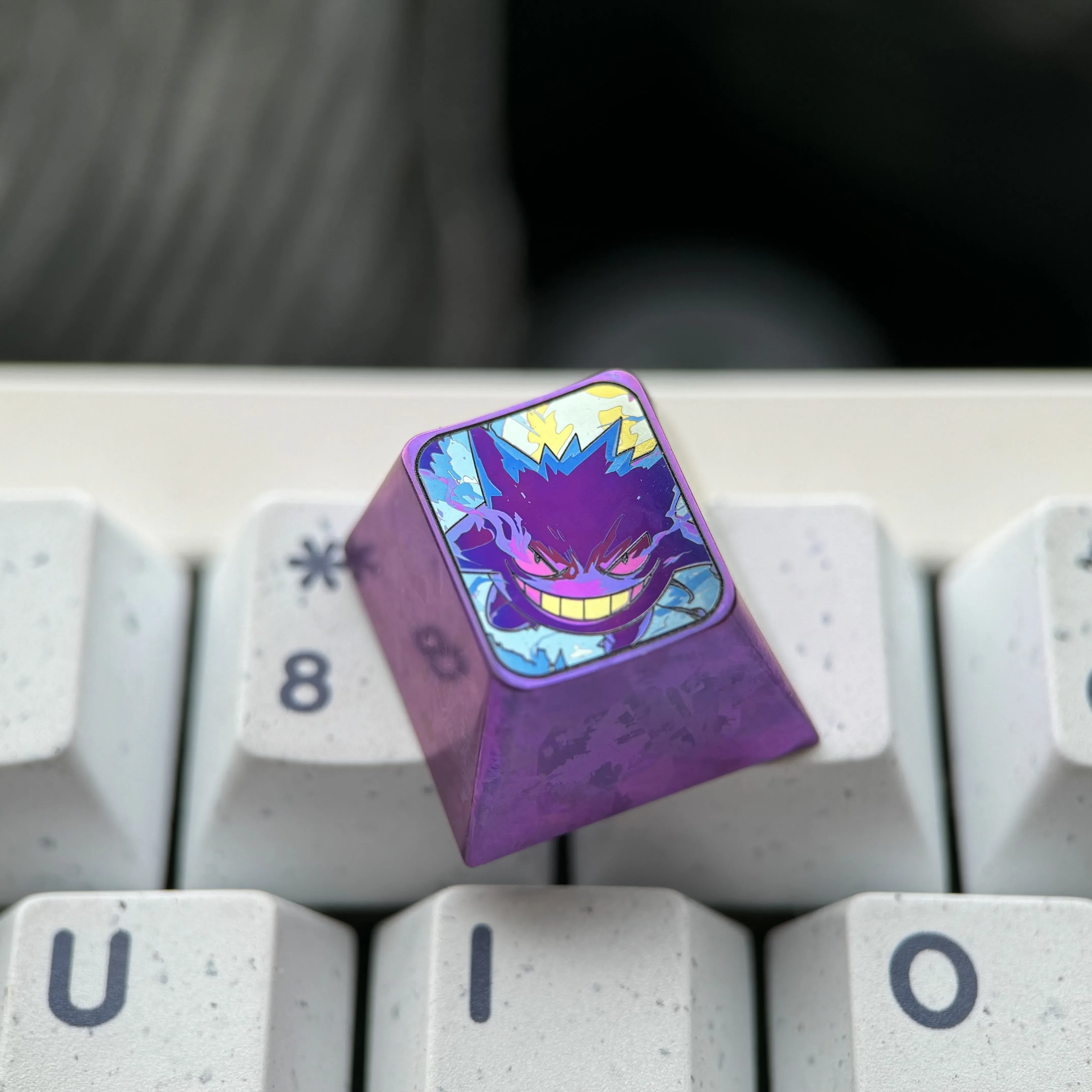 Vibrant Gengar titanium artisan ESC keycap for mechanical keyboards, beautifully crafted from colored titanium alloy with intricate anime details.