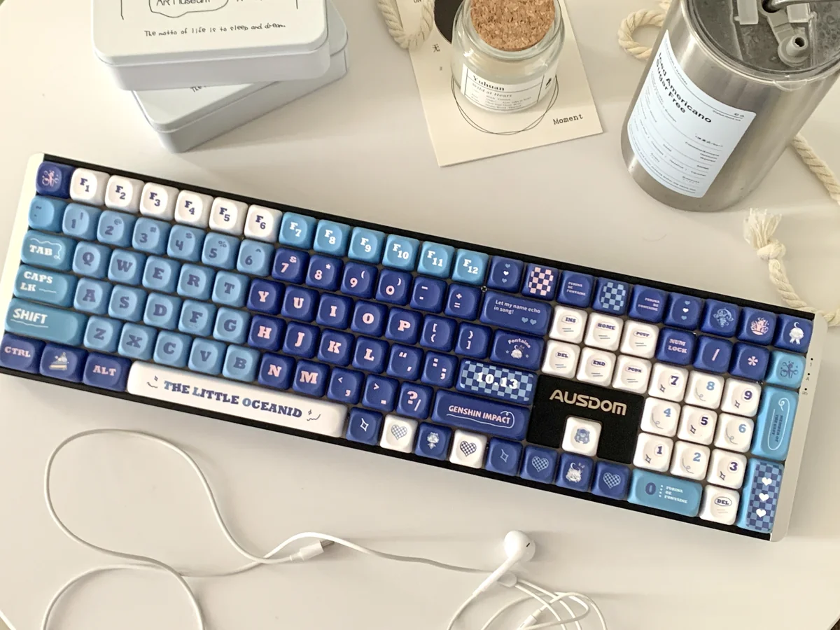 Exclusive Furina PBT dye-sub keycap set, showcasing elegant blue, white, and gold Genshin Impact Fontaine motifs.