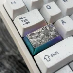 Close-up views of premium Genshin Impact titanium keycaps, featuring engraved Raiden Shogun and Yae Miko anime art from various angles.