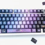 Exclusive Genshin Impact Wanderer PBT Keycaps set showcasing mystical blue-purple hues, elegant character motifs, and an artistic anime aesthetic.