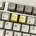 Two Premium Gold Keycaps crafted from zinc-aluminum alloy, featuring intricate laser-engraved details for a luxurious keyboard accent.