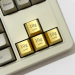 Four Premium Gold Keycaps crafted from zinc-aluminum alloy, feature an opulent electroplated finish and laser-engraved details.