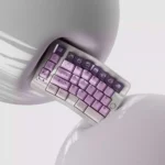 Whimsical Grape Milkshake PBT keycaps set displayed from various angles, highlighting its unique dye-sublimated pastel purple and creamy white beverage design.