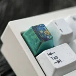 Close-up views of the premium titanium Hatsune Miku keycap, highlighting its vibrant anime design with sunflower and rich green accents from multiple angles.