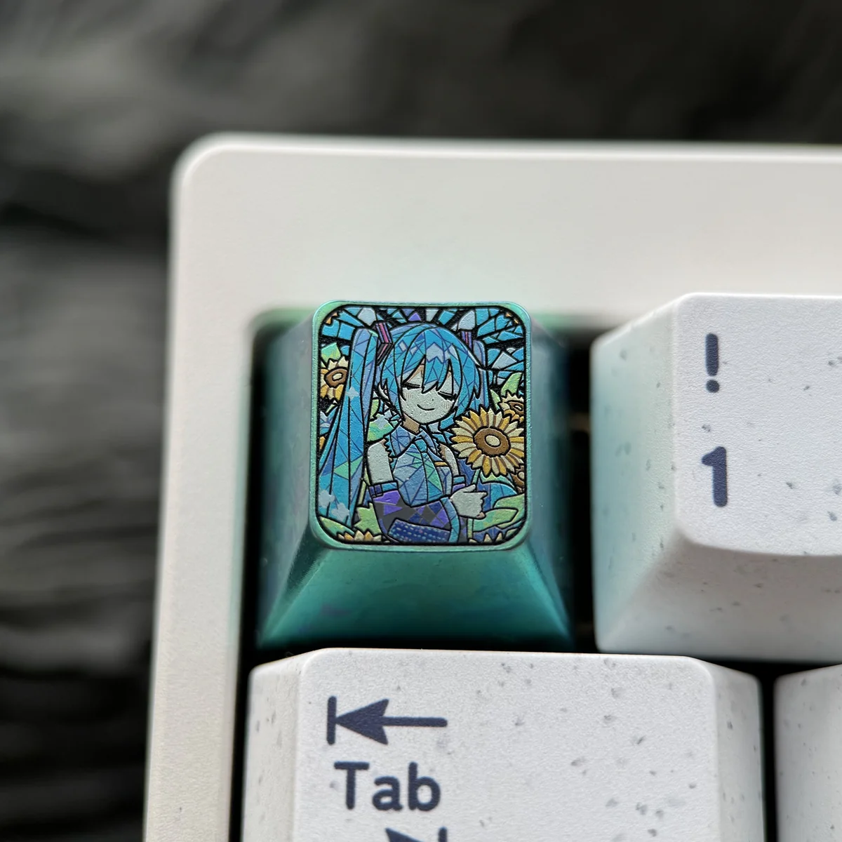 Iconic Hatsune Miku titanium keycap showcasing vibrant anime art, a premium ESC key with sunflower motif and rich green accents.