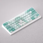 Dynamic collection of vibrant Hatsune Miku PBT keycaps set, showcasing side-engraved legends, brilliant backlighting, and anime-inspired blue design.
