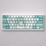 Vibrant Hatsune Miku PBT keycaps set for mechanical keyboards, displaying side-engraved legends with dynamic blue backlighting.