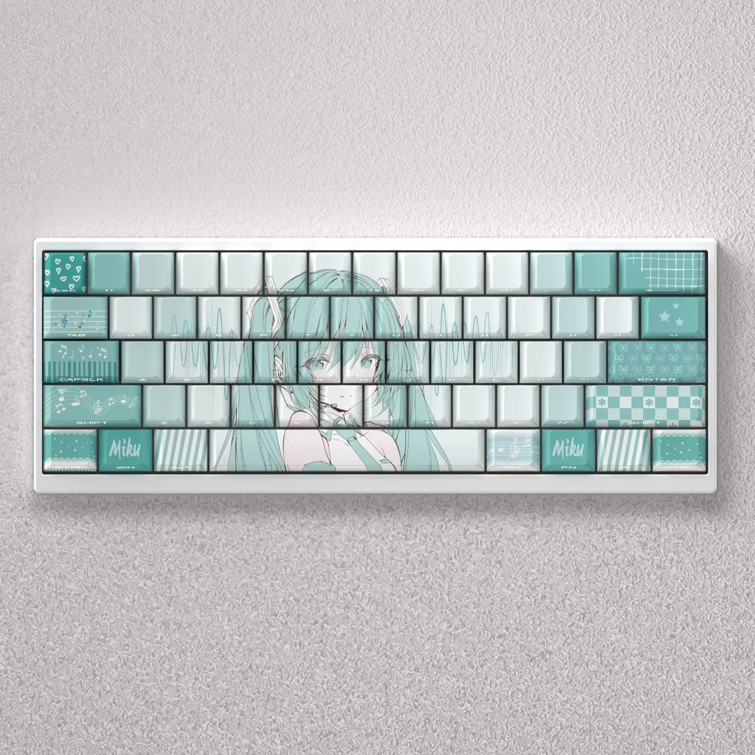 Vibrant Hatsune Miku PBT keycaps set for mechanical keyboards, displaying side-engraved legends with dynamic blue backlighting.