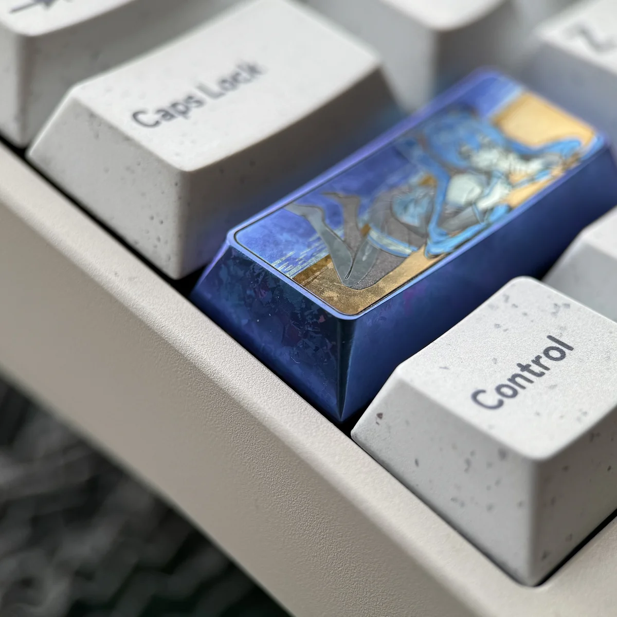 Close-up views of the Hatsune Miku Titanium Artisan Keycap, highlighting its vibrant cyber-pop design and premium anodized finish from multiple angles