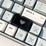 Luminous Heart Shaped Keycap. Various views show its subtle illuminated heart and double-shot design on a dark design.