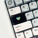 Multiple views of the Luminous Heart Shaped Keycap, showcasing its subtle illuminated heart motif and sleek dark design.