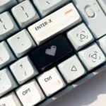 Multiple angles of the artistic Luminous Heart Shaped Keycap with a subtle illuminated heart motif on its sleek, dark design.