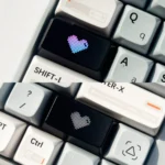 Artistic Luminous Heart Shaped Keycaps, featuring a subtle illuminated heart motif on a sleek dark design.