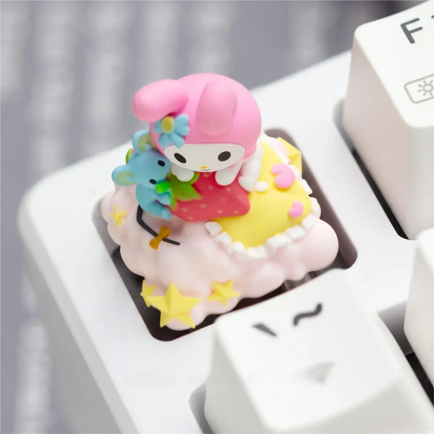 A whimsical handcrafted Hello Kitty: Characters resin keycap for custom mechanical keyboards, featuring the iconic character as a vibrant, charming desktop setup.