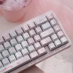 Hello Kitty PBT dye-sub keycaps set. Multiple views of the playful pink set, highlighting durable quality and iconic Hello Kitty characters.
