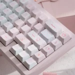 Hello Kitty PBT dye-sub keycaps set gallery. Playful pink mechanical keyboard set with iconic characters, shown from multiple angles.