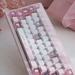 Hello Kitty PBT dye-sub keycaps set in playful pink, showcasing various iconic characters and durable PBT texture from different angles.