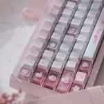 Hello Kitty PBT dye-sub keycaps set displayed from multiple angles, highlighting vibrant pink colors and adorable iconic characters.
