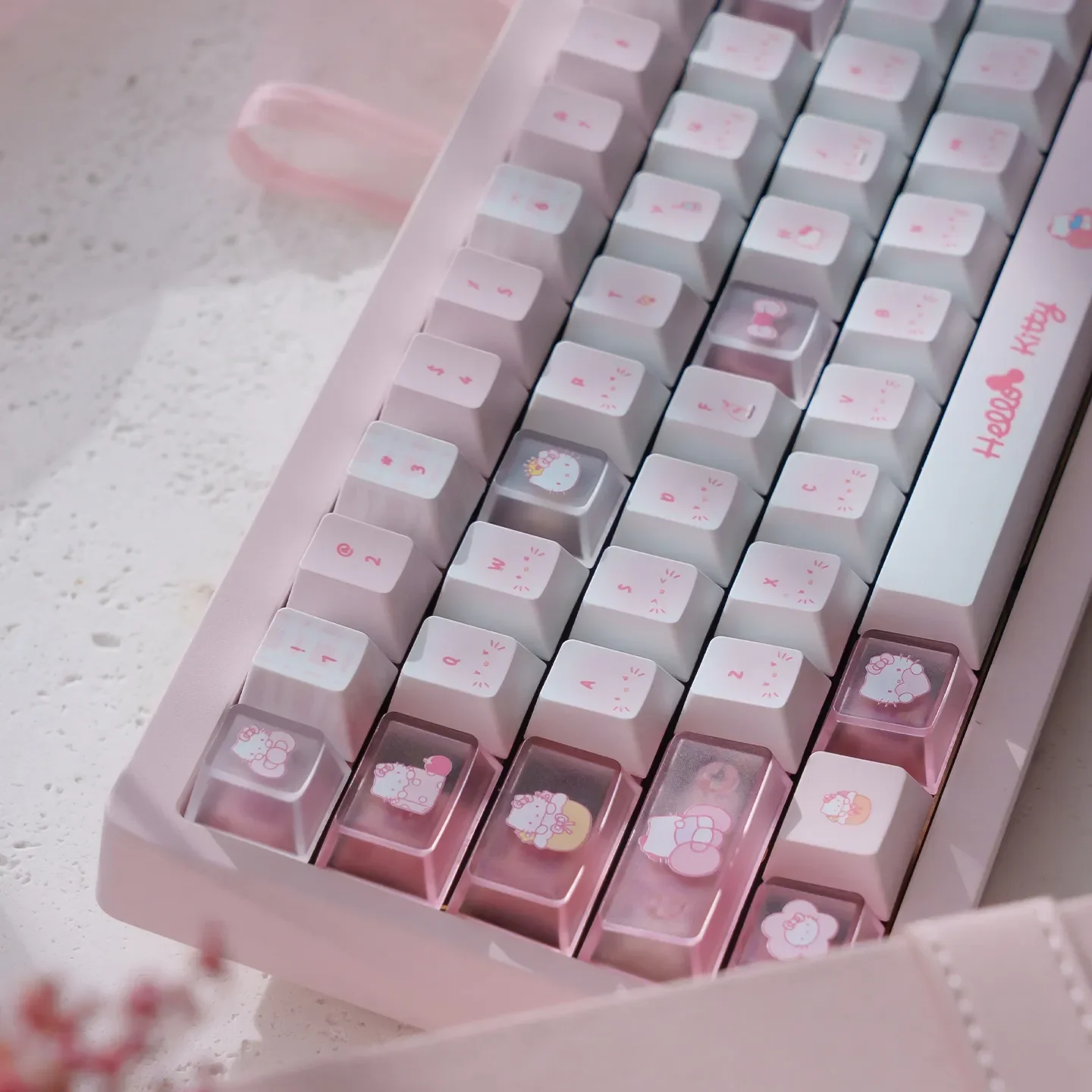 Hello Kitty PBT dye-sub keycaps set displayed from multiple angles, highlighting vibrant pink colors and adorable iconic characters.