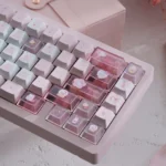 Full set of Hello Kitty PBT dye-sub keycaps set, showcased from various angles, highlighting durable construction and playful pink designs.