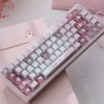 Official Hello Kitty PBT dye-sub keycaps set displayed in a playful pink palette, showcasing iconic characters and durable quality for mechanical keyboard.