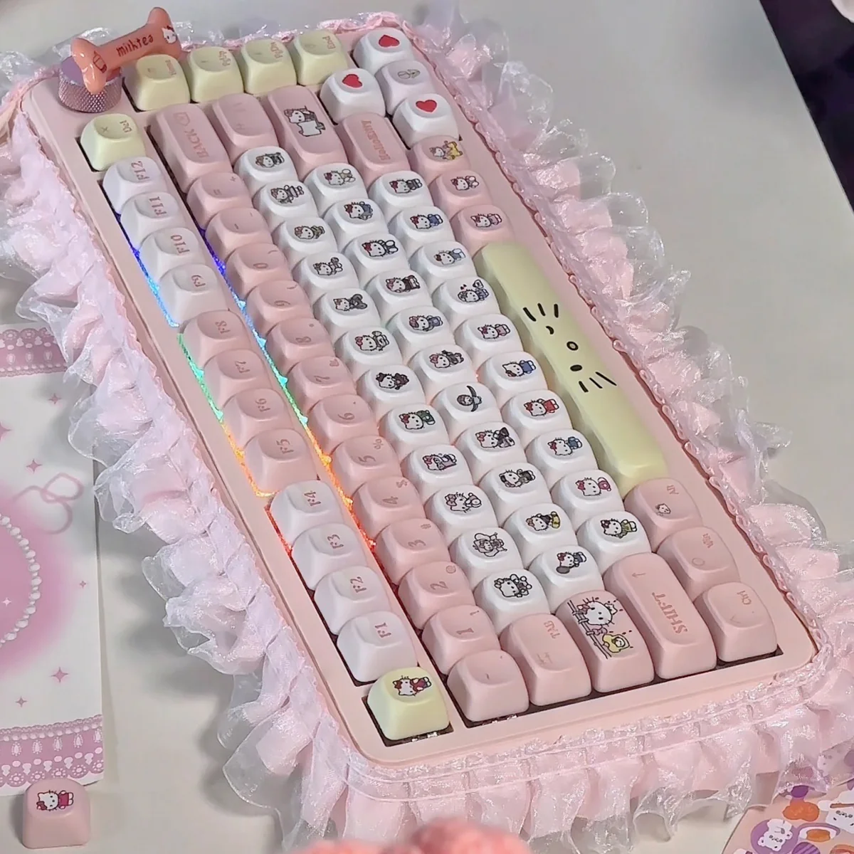Close-up view of Hello Kitty Joyful Pink Dye-Sub PBT keycaps set, revealing the iconic character designs and playful pastel pink hues from a unique angle.