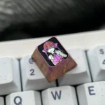 Close-up of a premium titanium Houshou Marine ESC keycap, featuring intricate VTuber anime craftsmanship and vibrant detail.