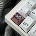 Artistic Houshou Marine titanium ESC keycap from a new angle, highlighting its vibrant anime character tribute and premium metallic craftsmanship.