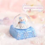 Magical Interactive Snowman Keycap showcasing a miniature crystal ball winter scene. Press to activate the adorable blue snowman jumping amidst design.