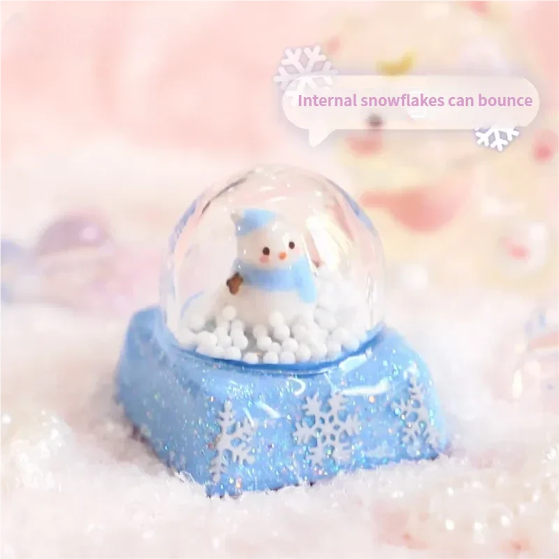 Magical Interactive Snowman Keycap showcasing a miniature crystal ball winter scene. Press to activate the adorable blue snowman jumping amidst design.