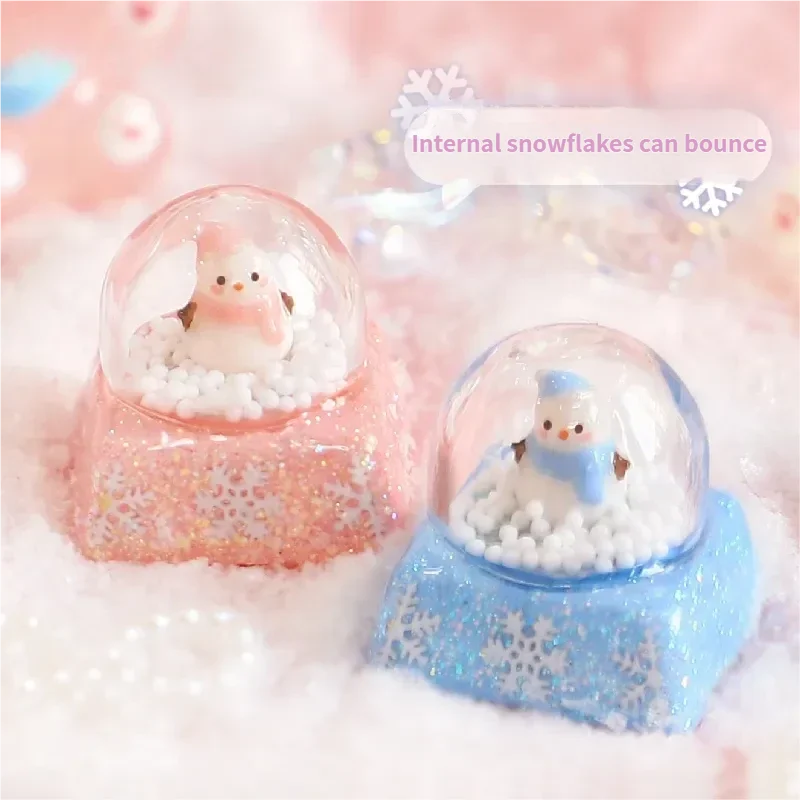 Magical Interactive Snowman Keycaps, featuring a miniature crystal ball winter scene. Press to activate the jumping blue snowman and sparkling design.